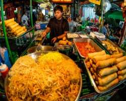 Don't miss the fun at Khao San Road on your trip t Don't miss the fun at Khao San Road on your trip to Bangkok, Thailand. It is full of street vendors who are selling spring rolls and pad thai at the l